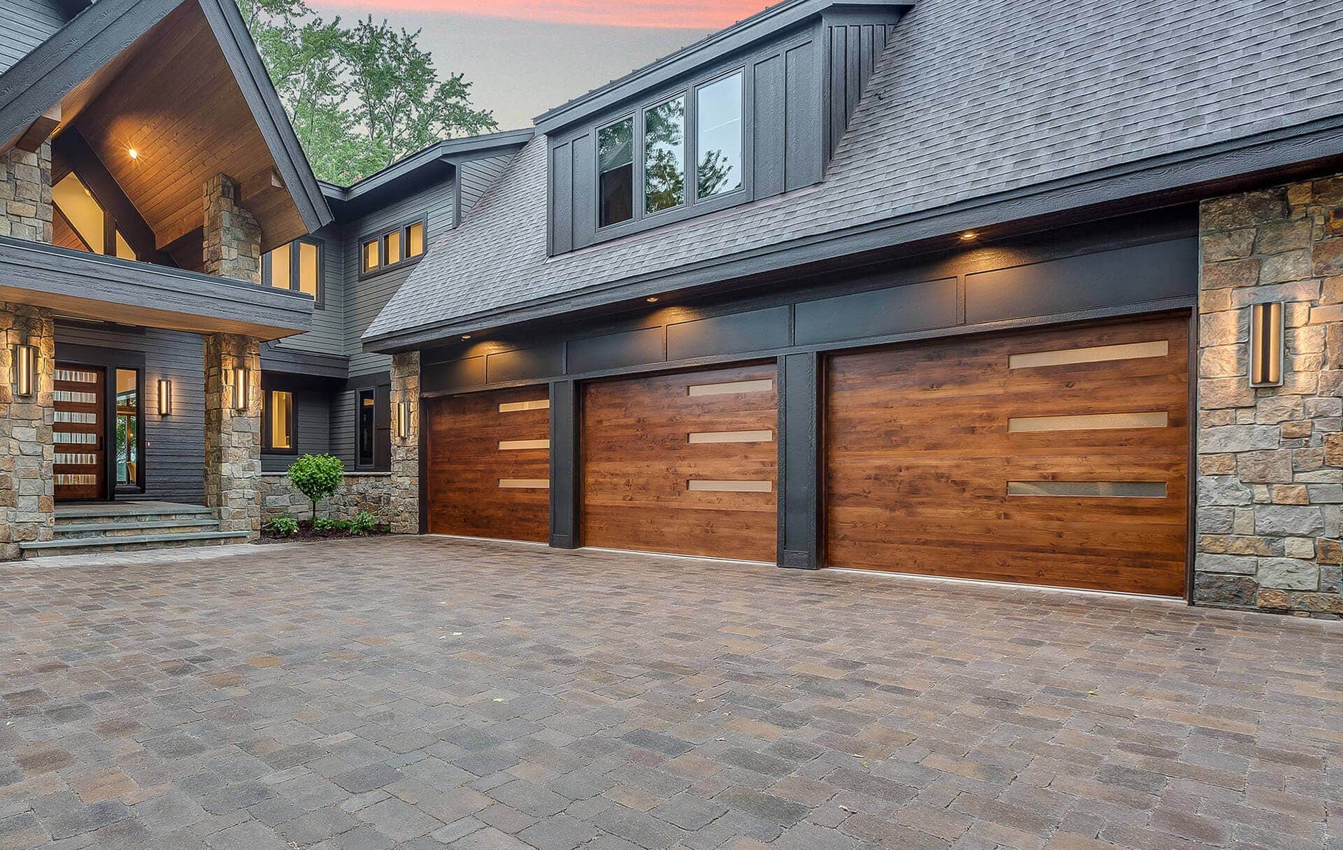 Stone house with nice wooden garage doors.